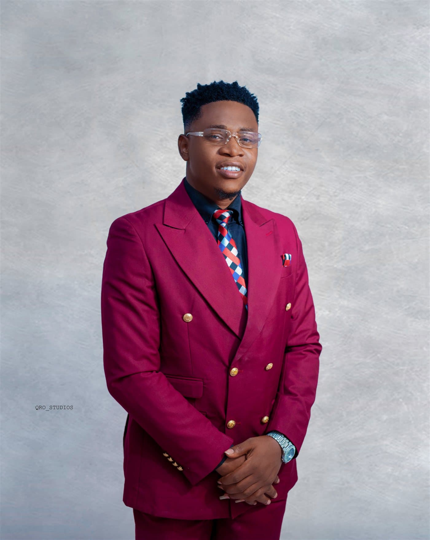 Tomide Williams in a burgundy suit